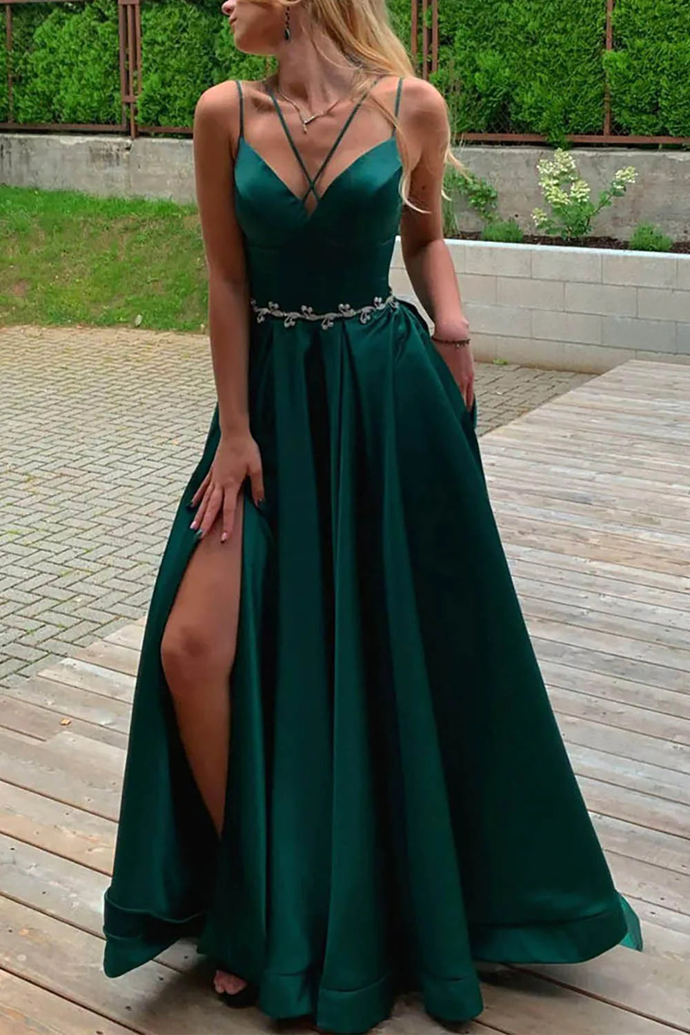 Model wearing an elegant A-Line satin prom dress with spaghetti straps and a high slit, posing gracefully.