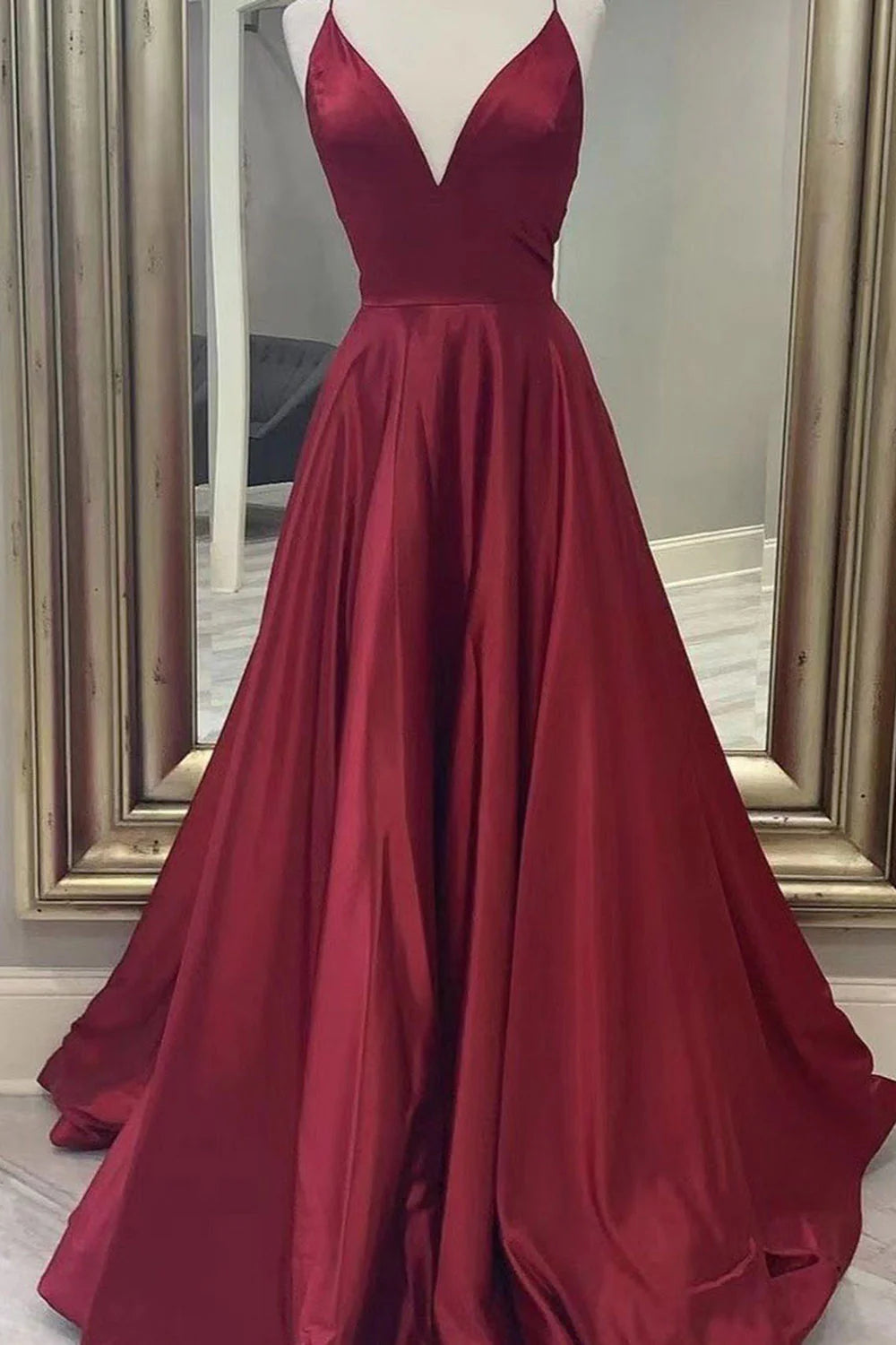 Elegant A-Line satin prom dress with spaghetti straps, front view.
