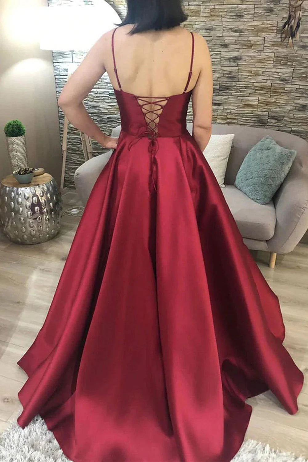 Back view of an A-Line satin evening dress with delicate spaghetti straps.