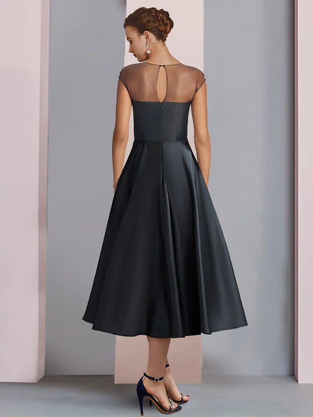 Close-up of the satin fabric and pleat detail on the A-Line dress.