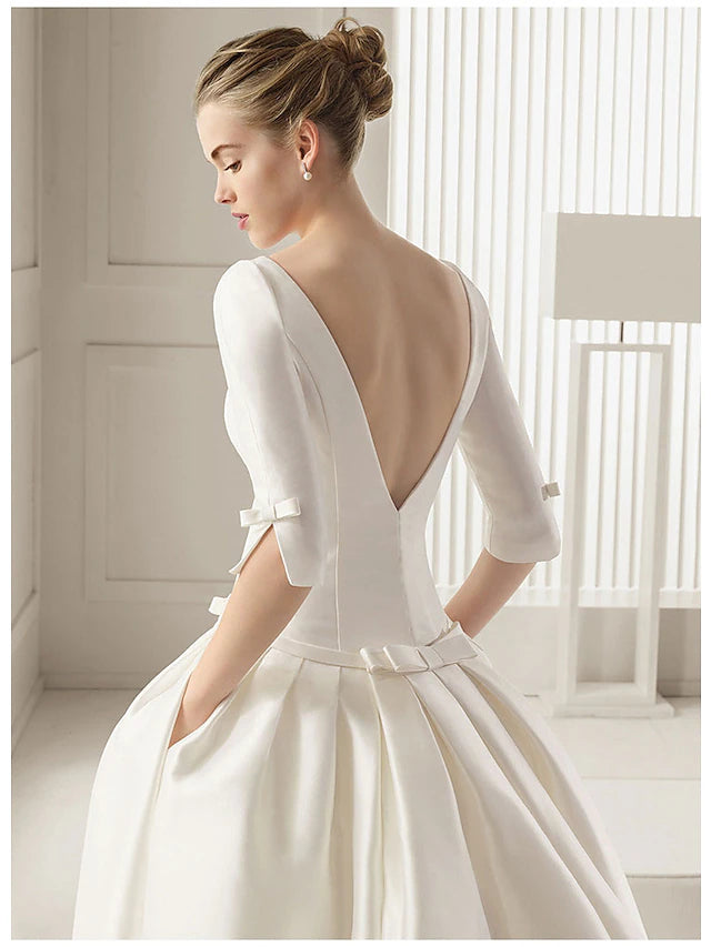 Close-up of the satin fabric and pleats on the wedding dress.