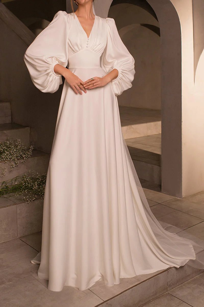 Elegant A-line satin wedding dress with V-neck, long sleeves, and sweep train, viewed from the front.