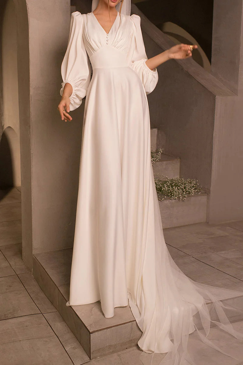 Side profile of the elegant A-line satin wedding dress, highlighting the V-neck and flowing silhouette.