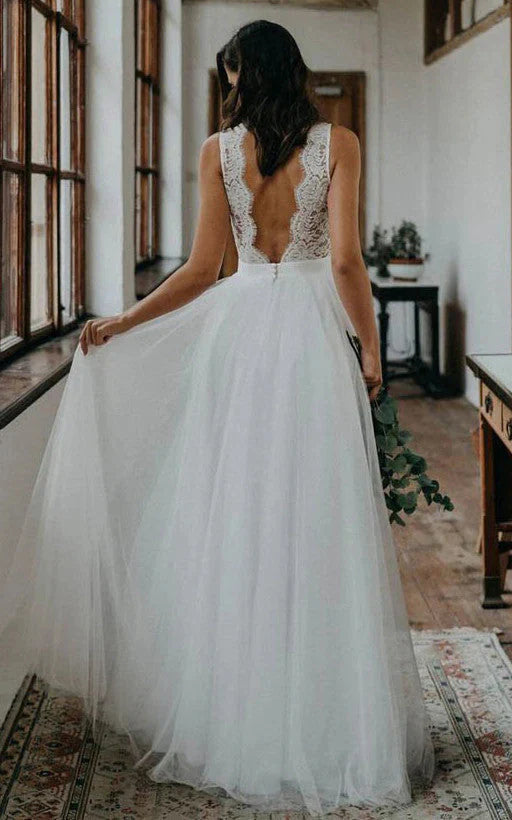 Close-up of the delicate lace and scalloped V-neck detail on the wedding dress.