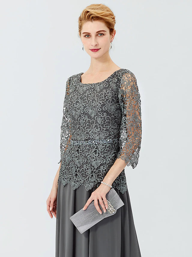 Detail of the 3/4 length sleeve and scoop neckline on an elegant dress.