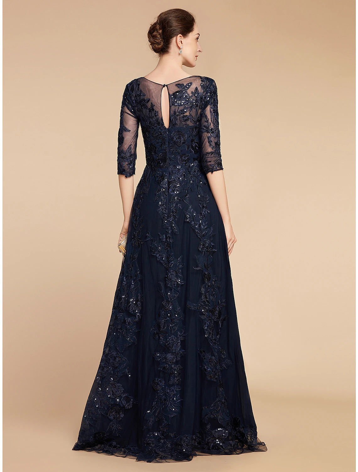 Back view of A-line chiffon lace gown with sequin details.
