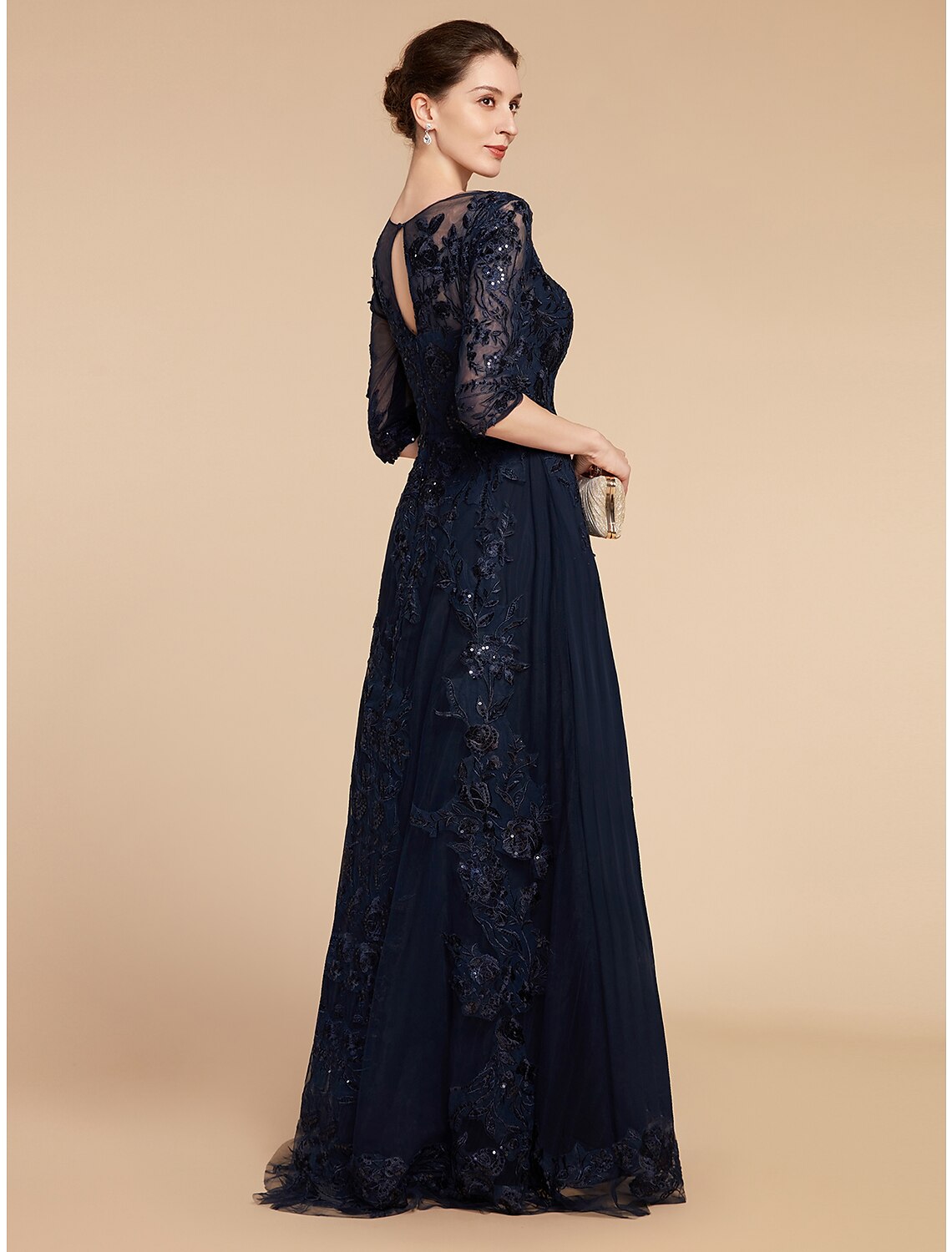 Close-up of sequin appliques and lace detail on a formal dress.