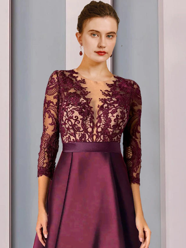 Back view of the high-low asymmetrical tea length Mother of the Bride gown, showcasing intricate lace details.