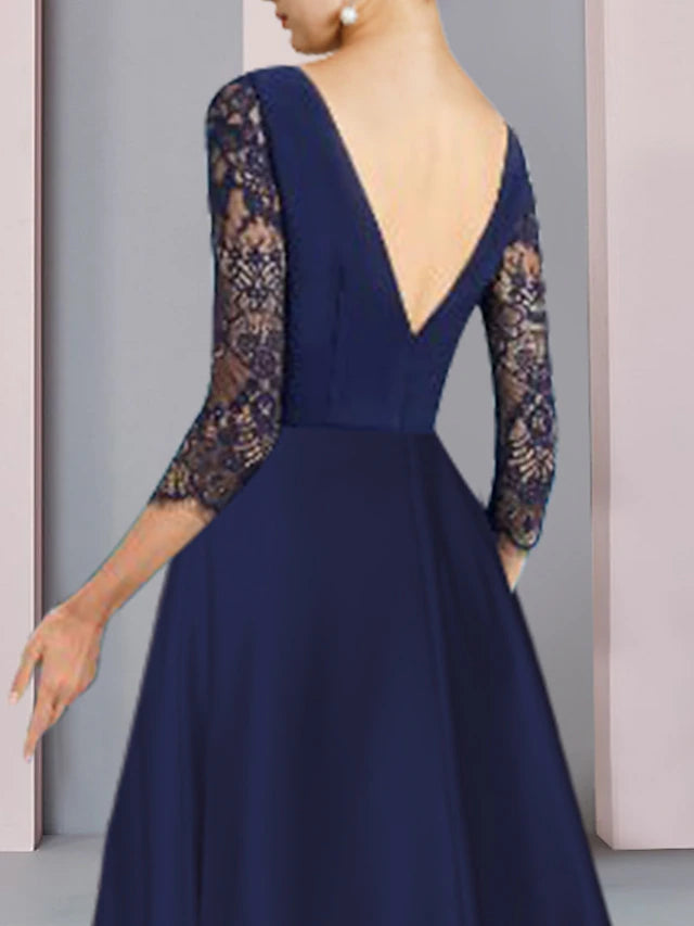 Knee-length formal dress featuring stretch lace fabric and crystal brooch detail.