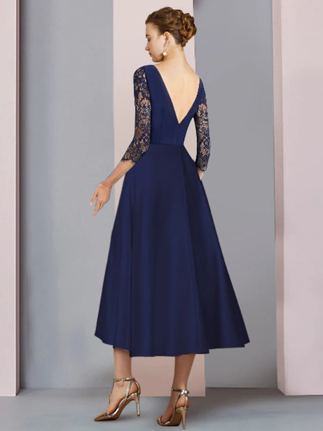 Close-up of the lace fabric and crystal brooch on the elegant knee-length dress.
