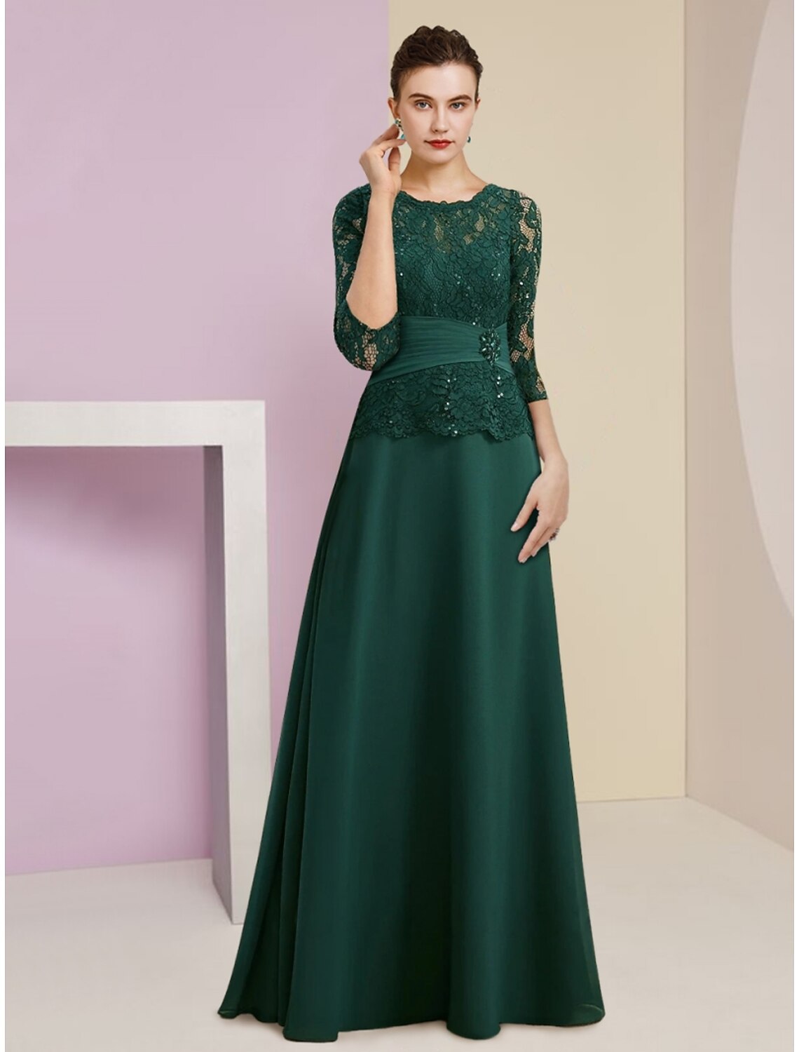 Woman wearing an elegant A-line mother of the bride dress with scoop neck and 3/4 sleeves.