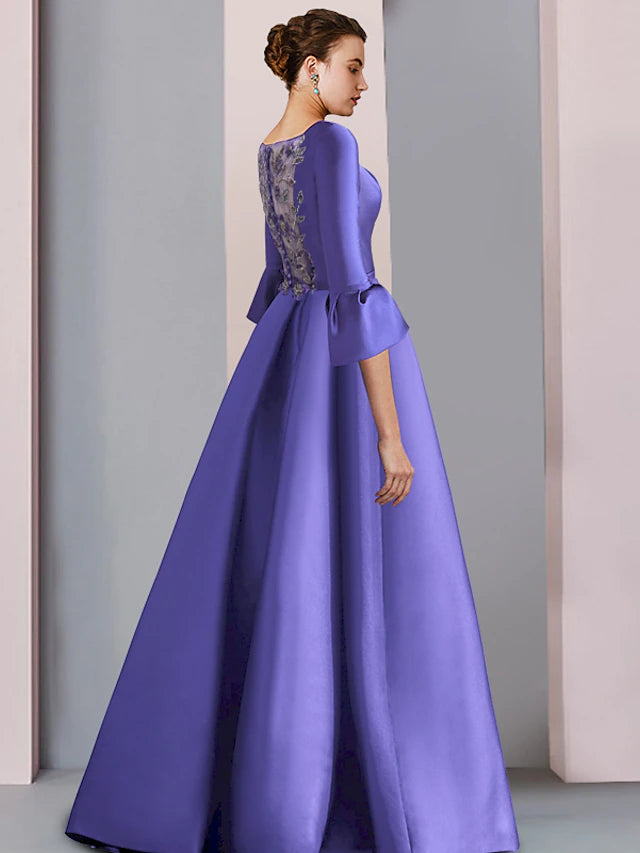 Back view of satin A-Line gown showing pleats and bow detail.