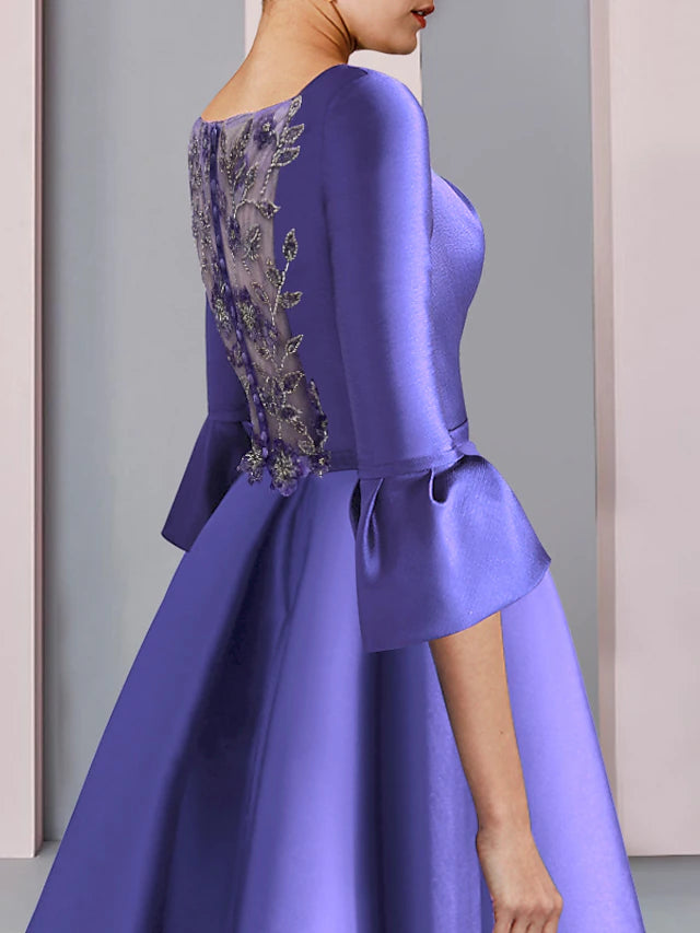 Side view of floor-length formal dress with intricate embroidery.