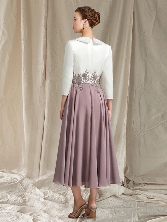 Tea-length Mother of the Bride dress featuring lace appliques and pleats.