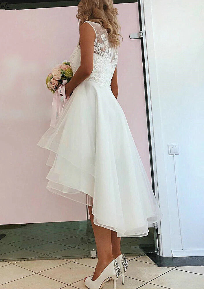Close-up of the delicate lace and asymmetrical hem on the A-Line wedding dress.