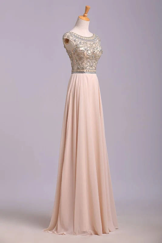 Side view of a model showcasing the silhouette of a beaded A-line floor length gown.