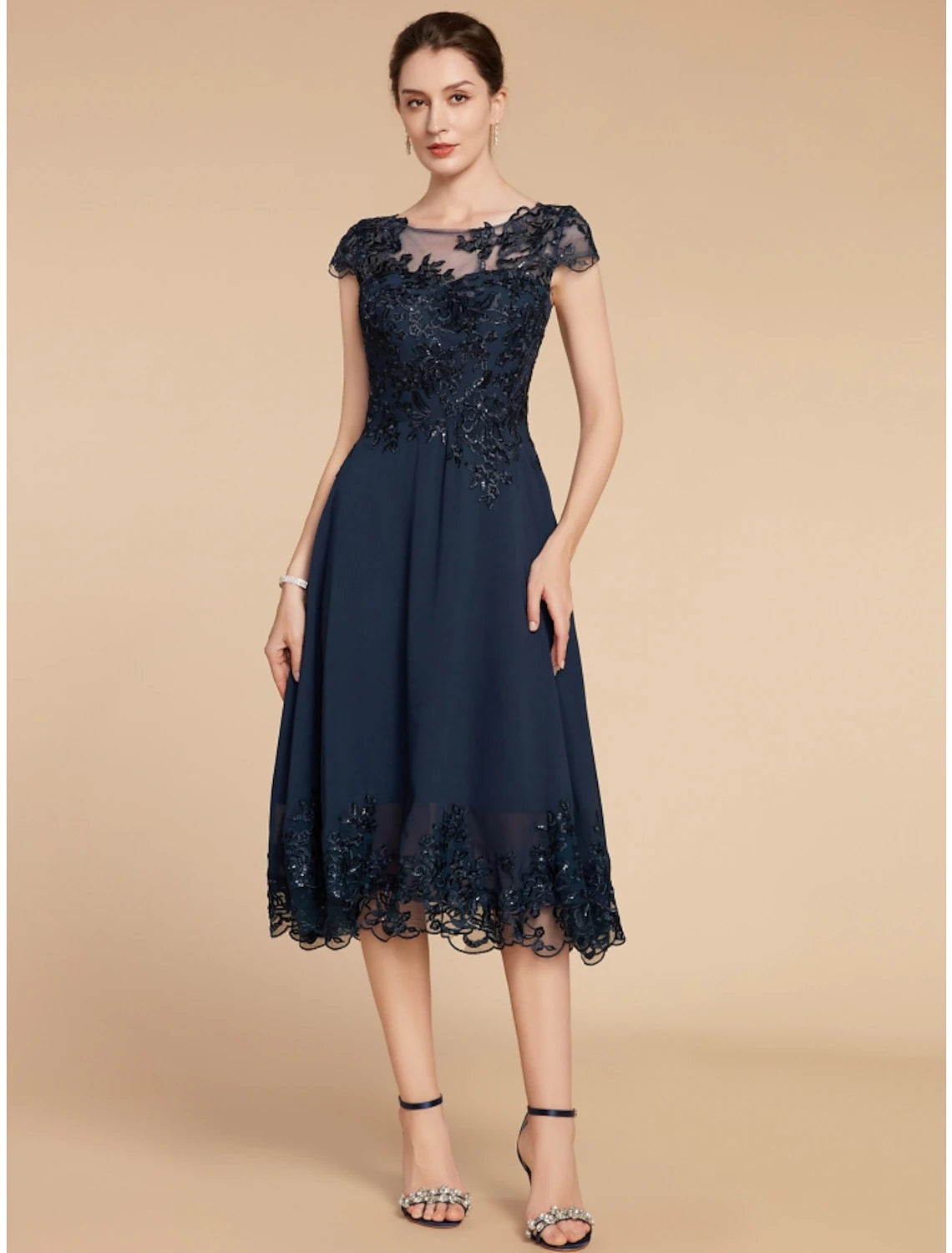 Elegant A-line mother of the bride dress with scoop neck and cap sleeves.