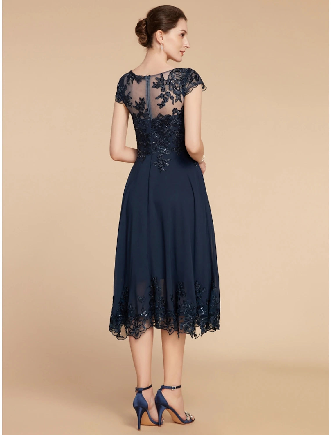 Back view of the tea length chiffon-lace dress with sequin ruching.