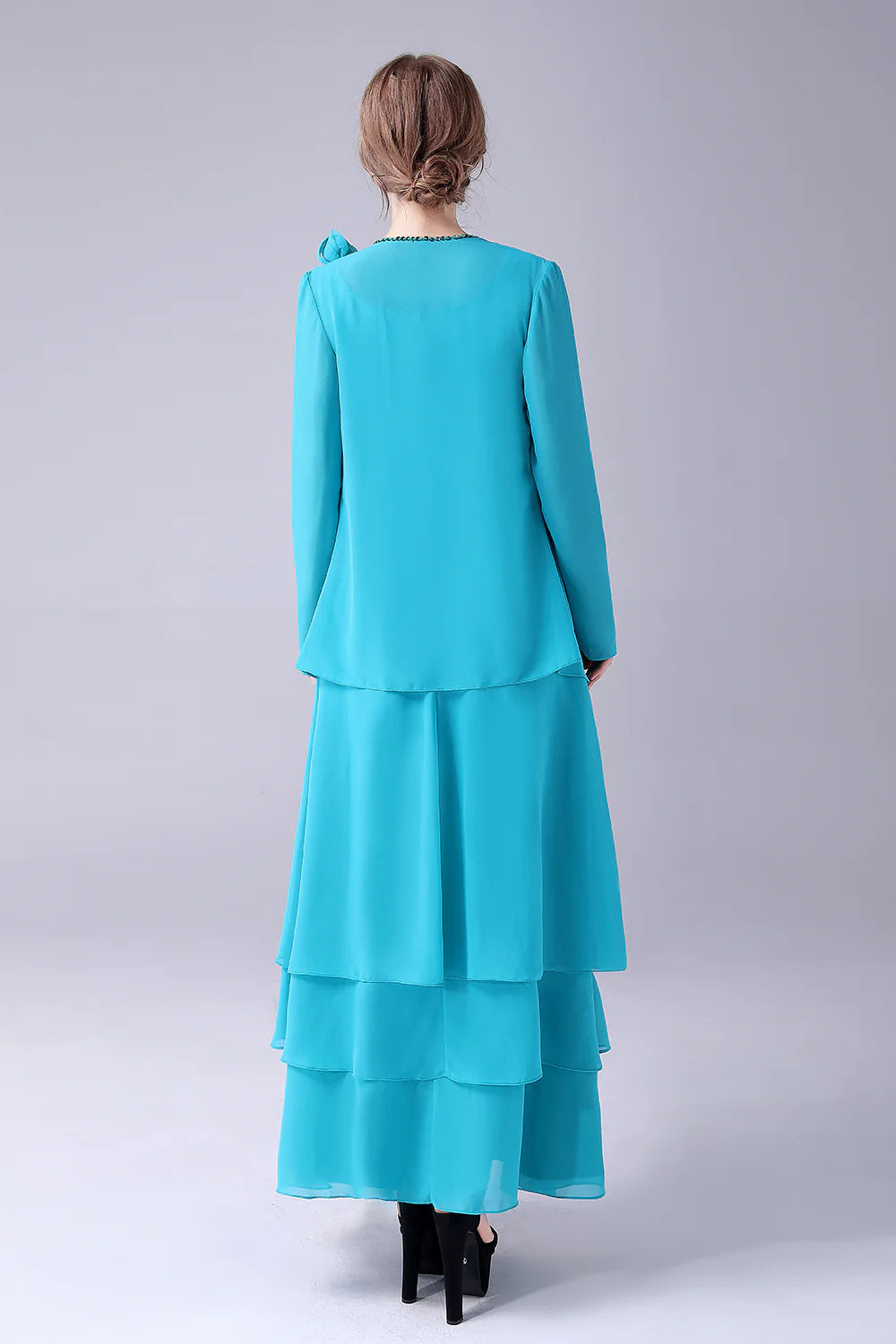Side view of a blue chiffon floor-length dress.