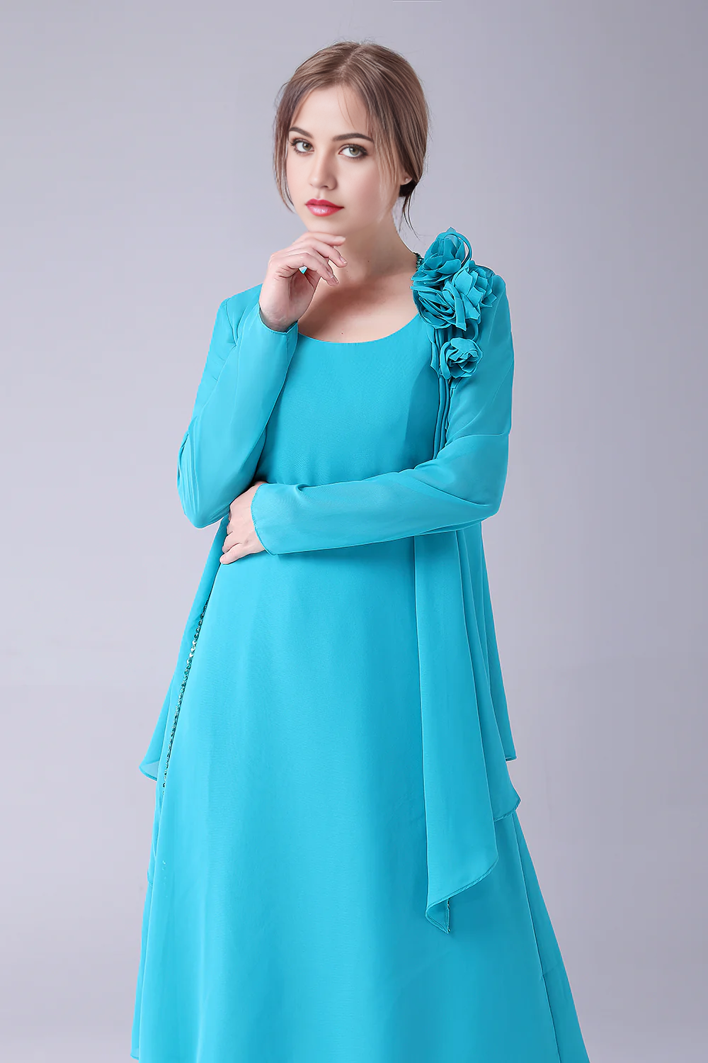 Close-up of the scoop neckline on a blue chiffon dress.
