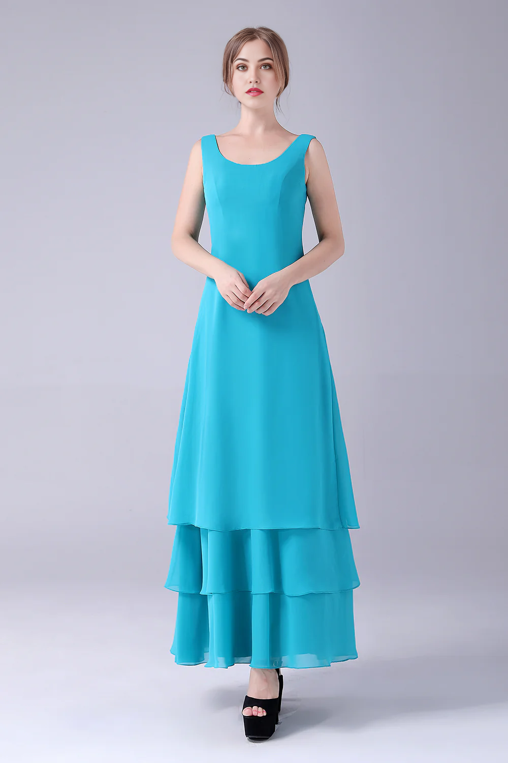 Model wearing a blue floor-length mother of the bride dress.