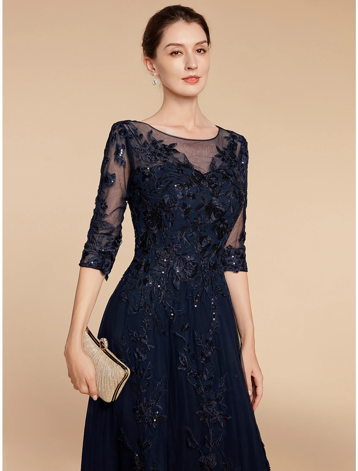 Side profile of the floor-length chiffon and lace dress.