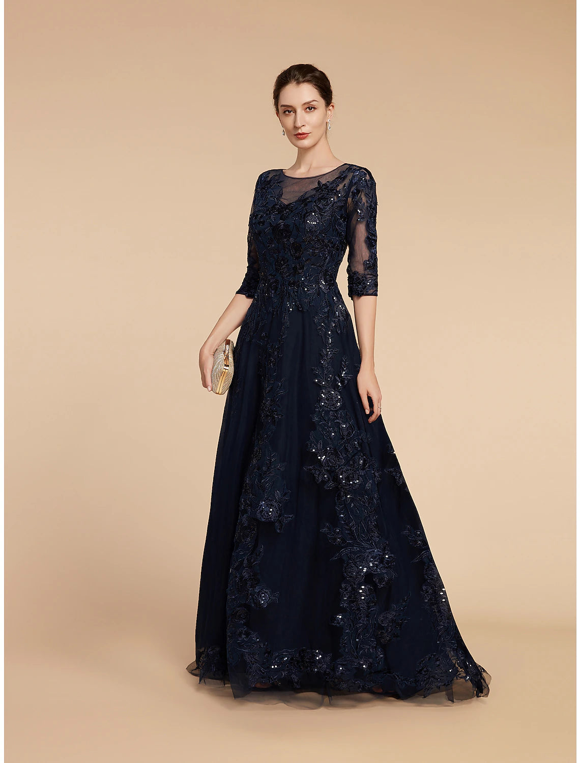 Detail of the 3/4 length sleeve and lace pattern on the elegant dress.