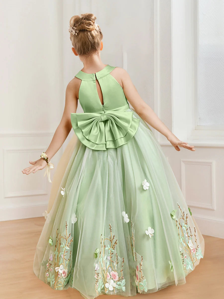 Close-up of delicate floral appliques on the bodice of a flower girl dress.