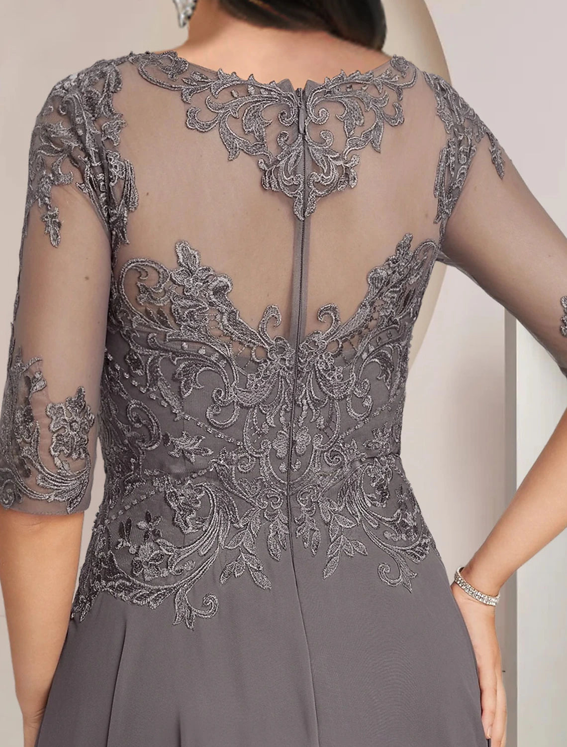 Back view of the formal tea length dress with delicate lace appliques.