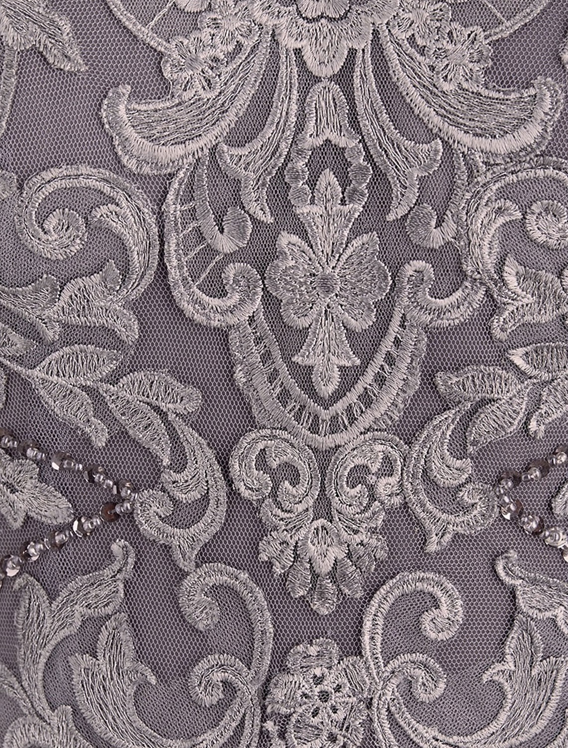 Close-up of chiffon and lace fabric with intricate appliques on the dress.
