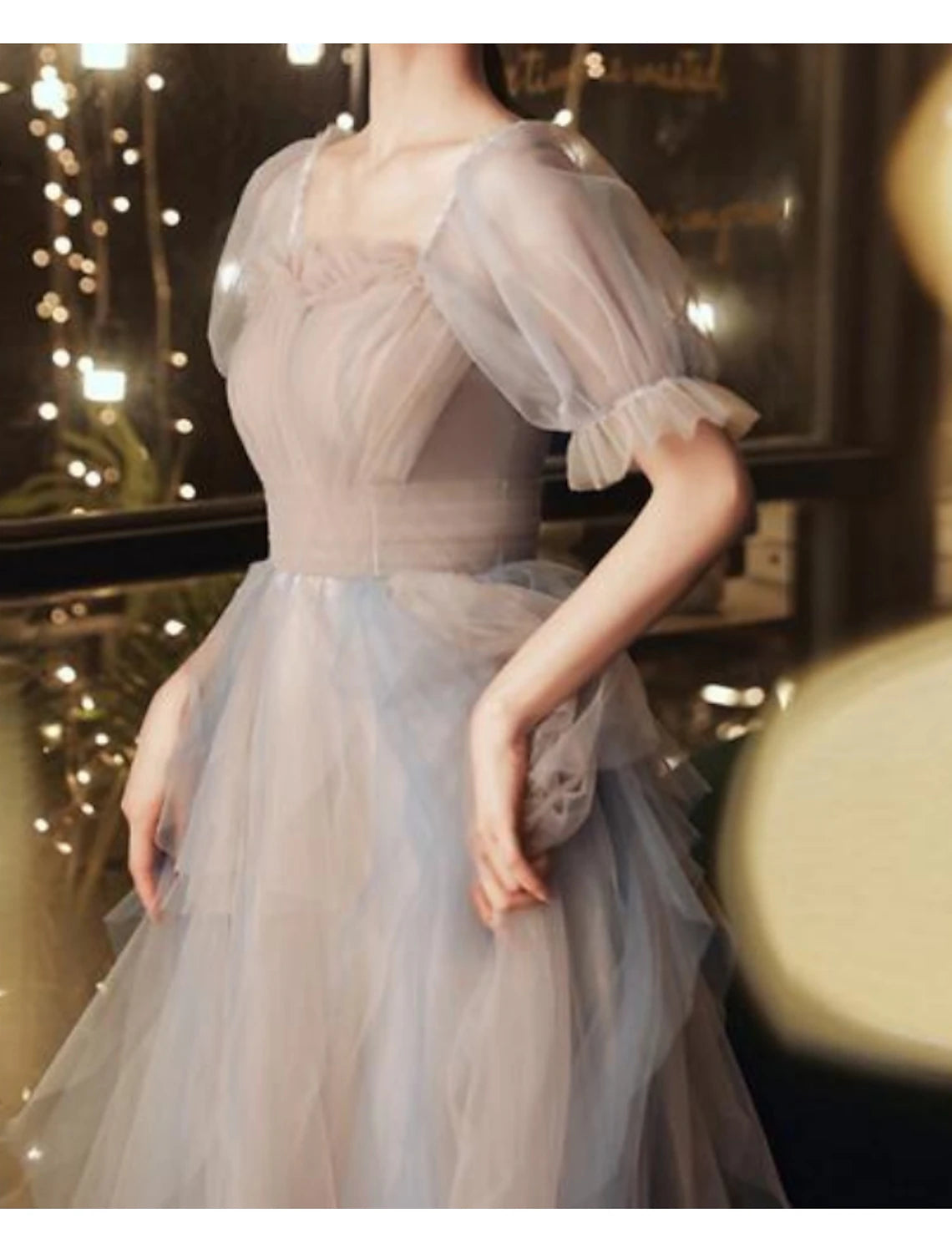 Close-up of the scoop neck and half sleeves on the color block A-line dress.