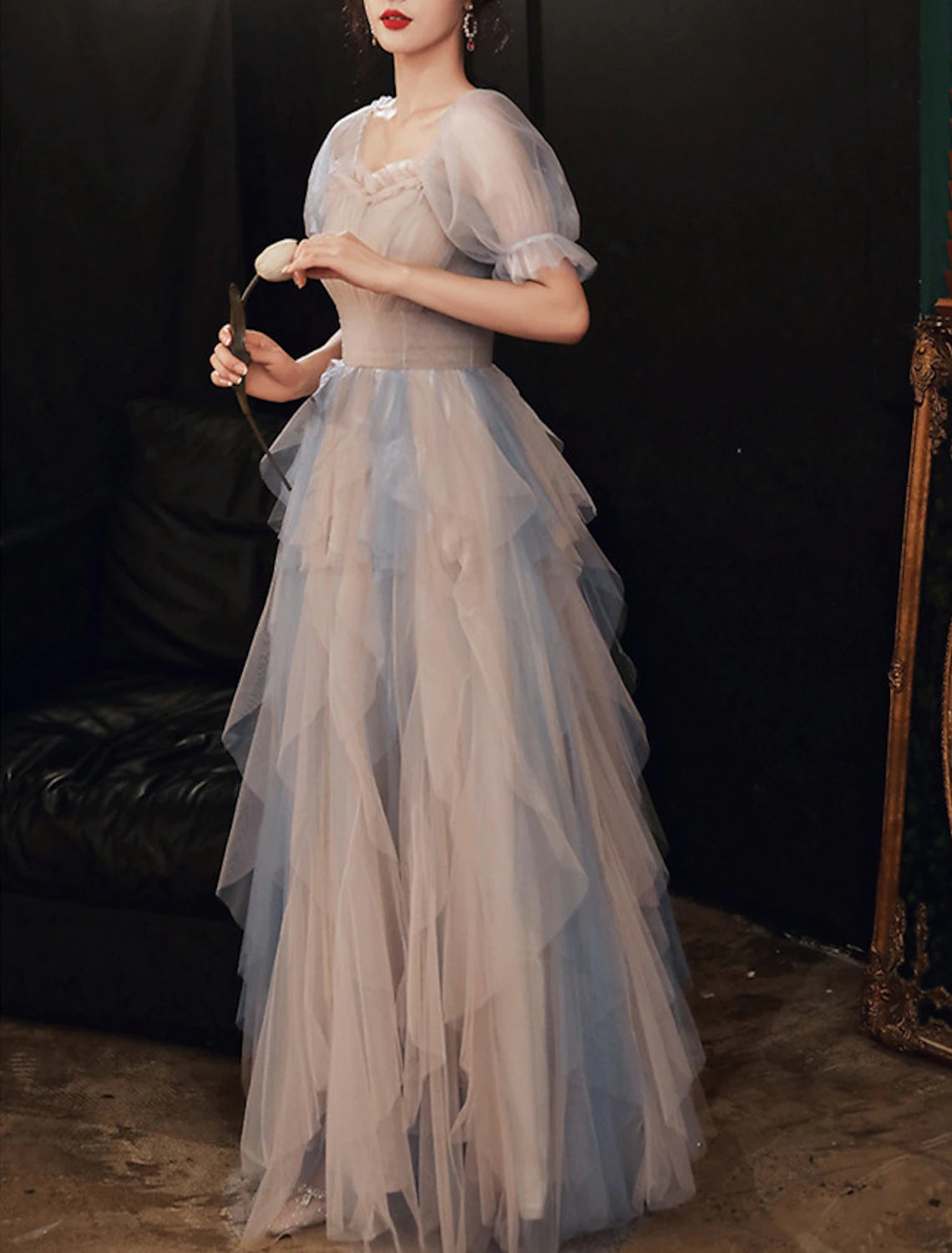 Side view of the flowing floor-length tulle dress, highlighting the fabric.