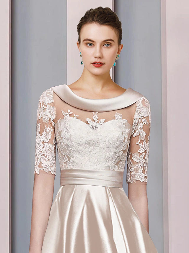 Close-up of lace appliques and satin fabric on an elegant formal dress.