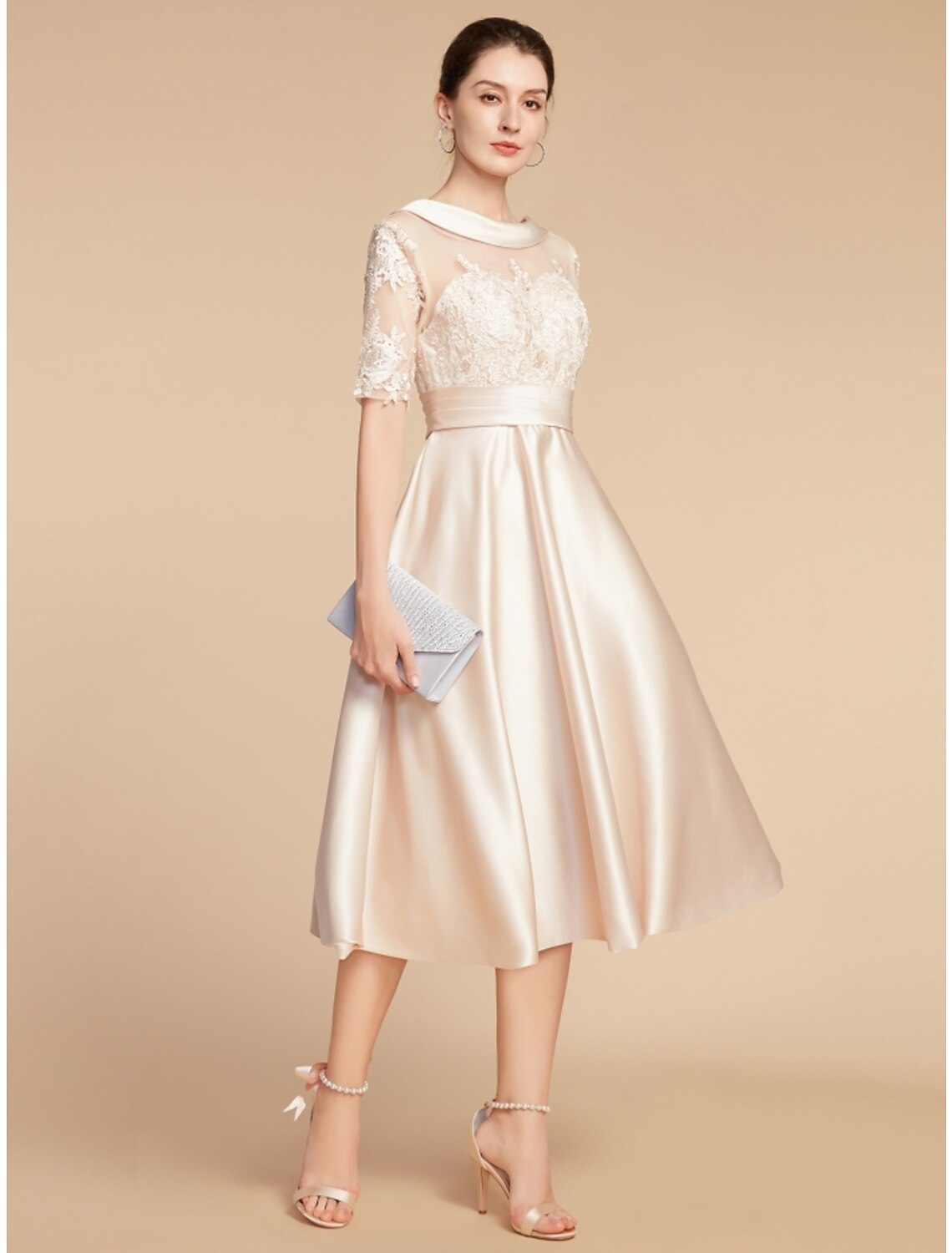 Close-up of the lace appliques and ruching details on the elegant A-line dress.