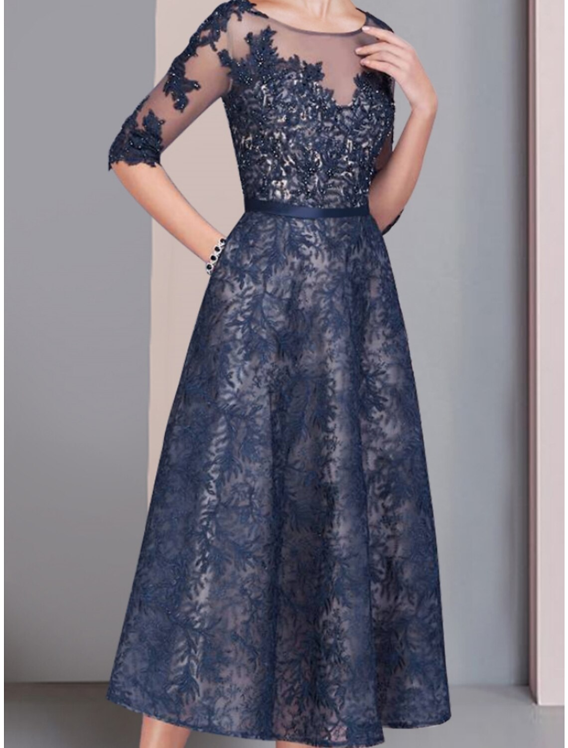Tea length wedding guest dress featuring ruching and solid color.