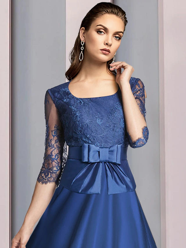 Back view of the tea length satin and lace dress with bow detail.