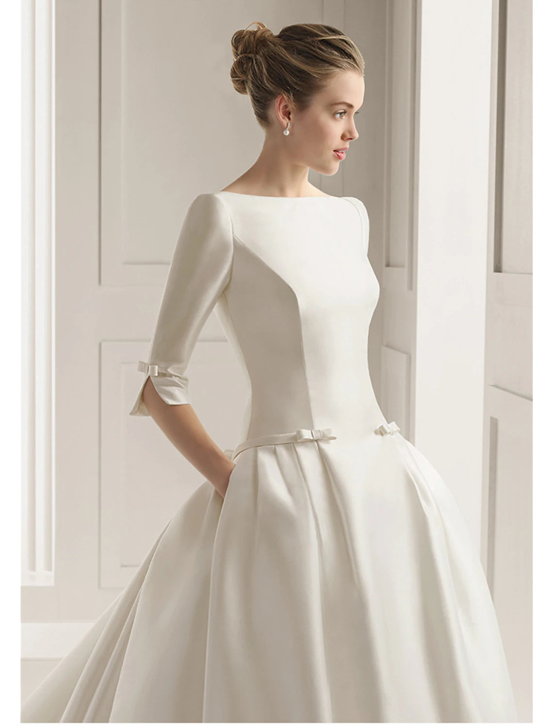 Detail of the bow and pleats on the elegant A-line wedding dress.