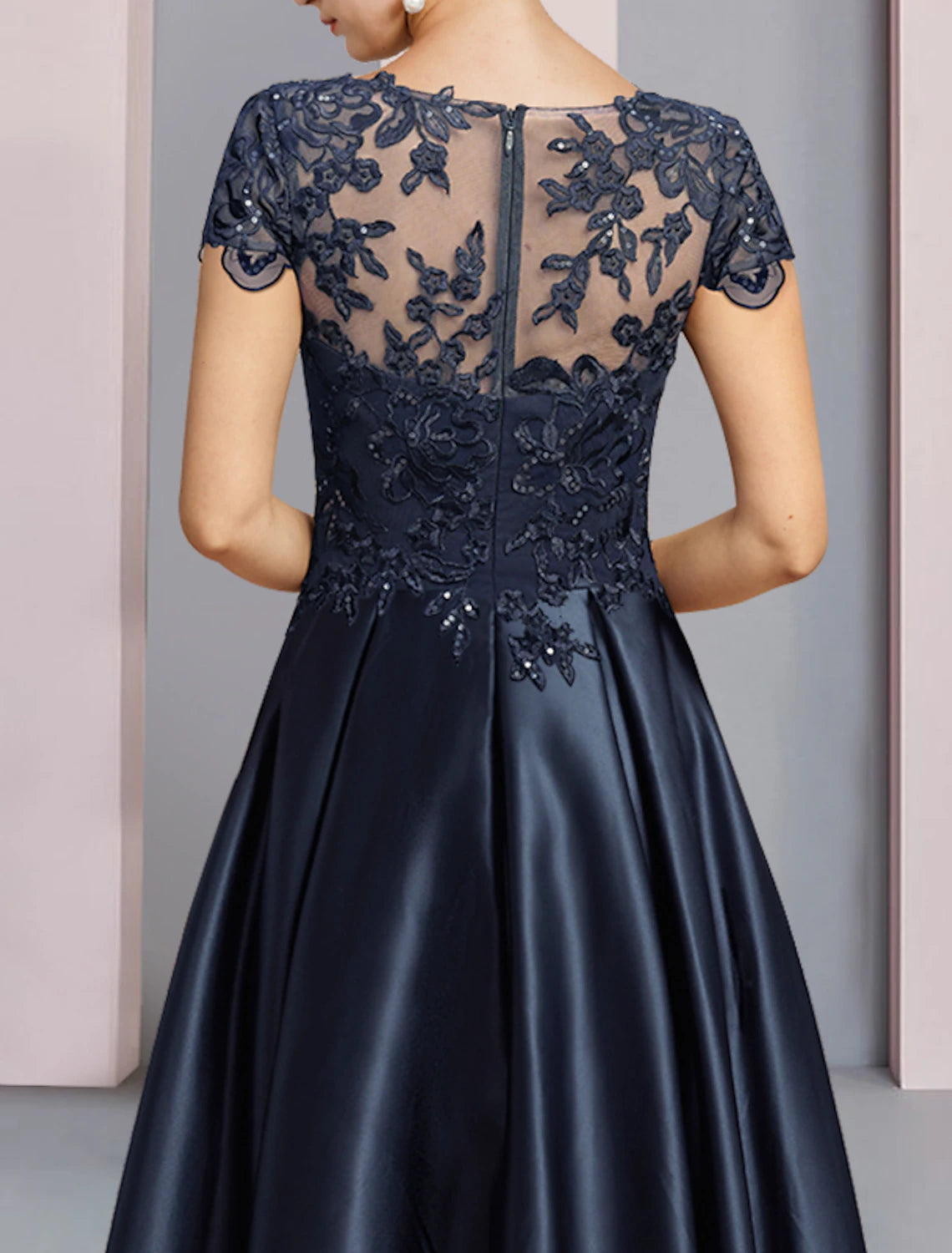 Side view of A-Line satin and lace dress with asymmetrical hem.