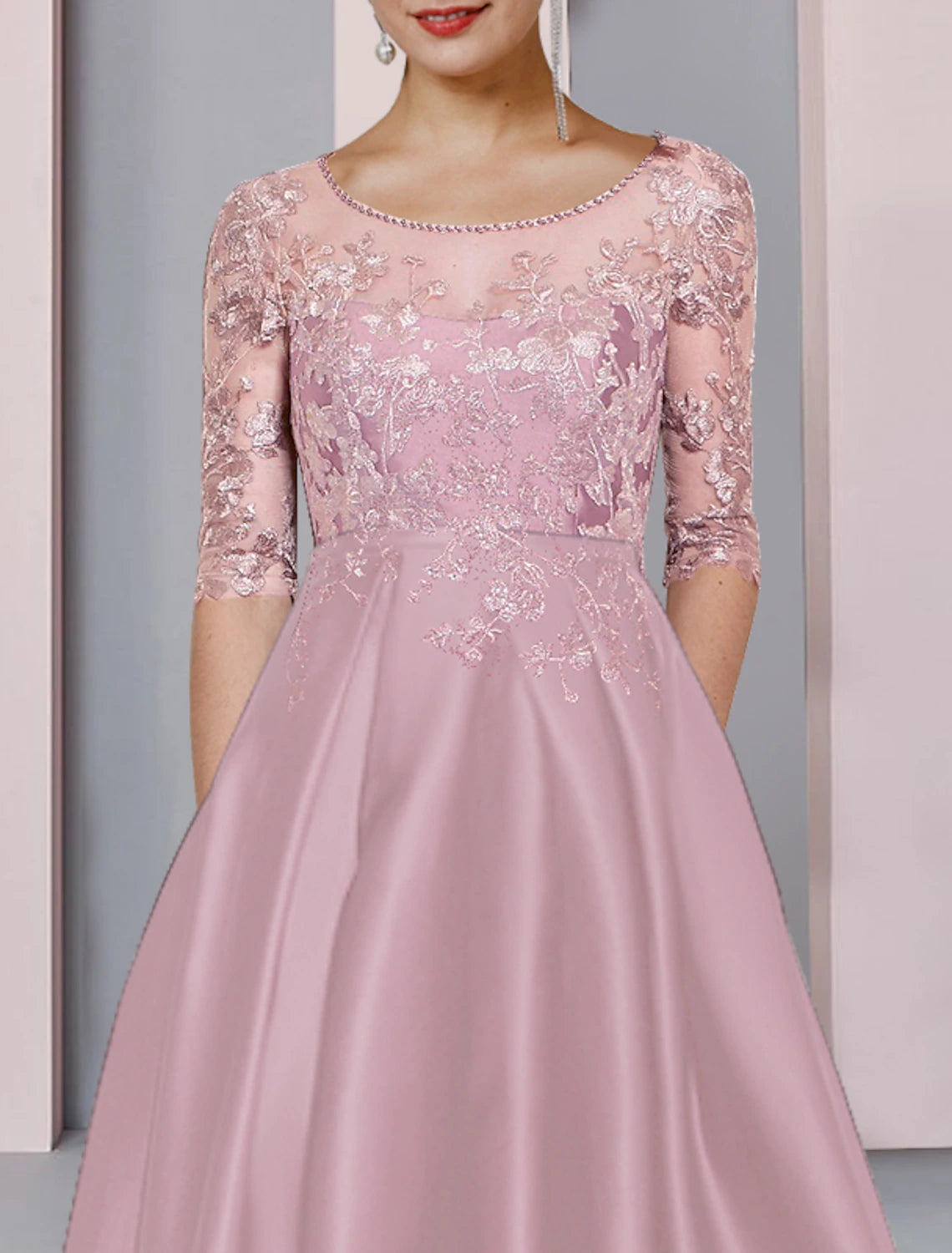 Back view of A-line Mother of the Bride dress showing high-low asymmetrical hem and lace details.