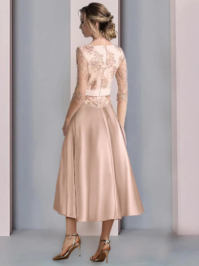 Close-up of delicate lace appliques and flower details on a satin half sleeve dress.