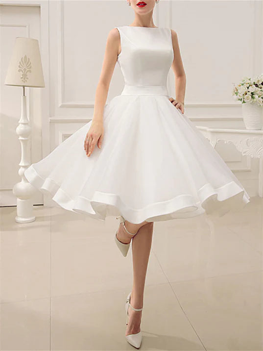 Back view of A-line wedding dress with delicate bow accent.