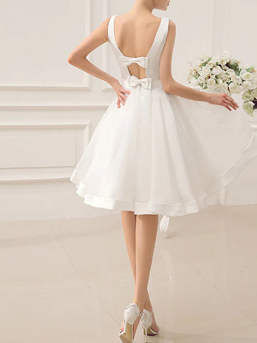 Side view of A-line knee-length bridal gown.