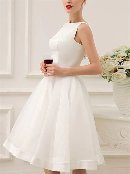 Front view of elegant knee-length wedding dress.