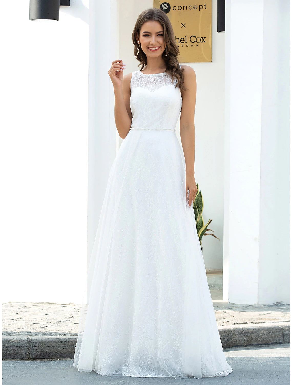 Bride wearing a floor-length A-line wedding dress on the beach.