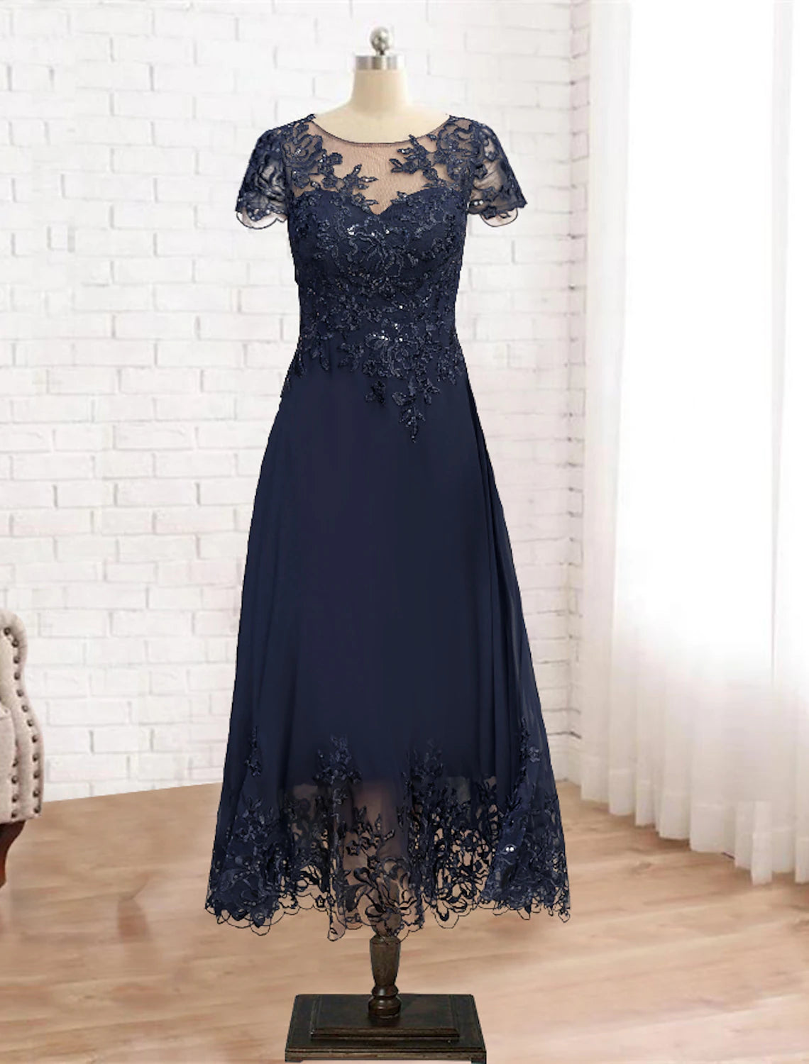 A-line mother of the bride dress with scoop neck and 3/4 lace sleeves.