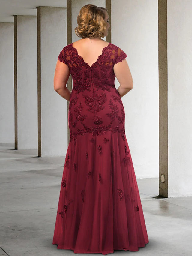 Plus size A-Line formal gown featuring intricate appliques and a floor-length silhouette.