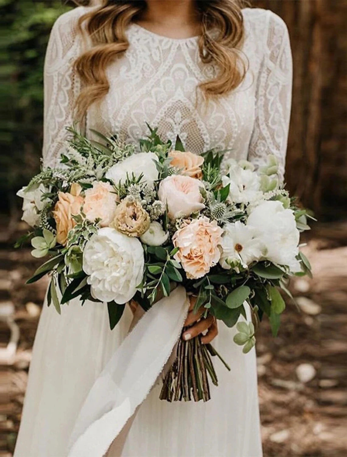 Close-up of the lace and applique details on a long sleeve wedding dress.