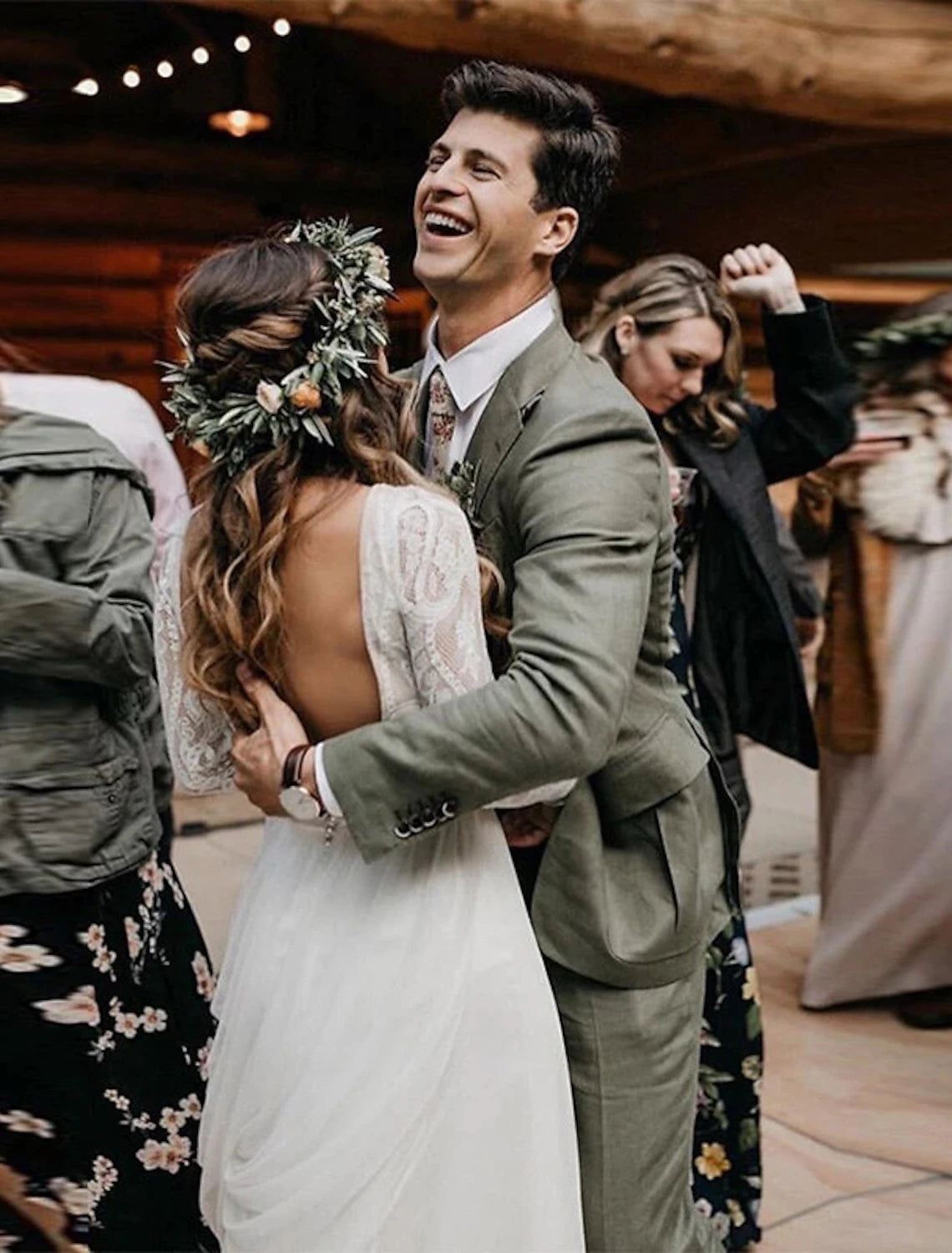 Side view of an A-line bridal gown with pleats and a long sleeve.