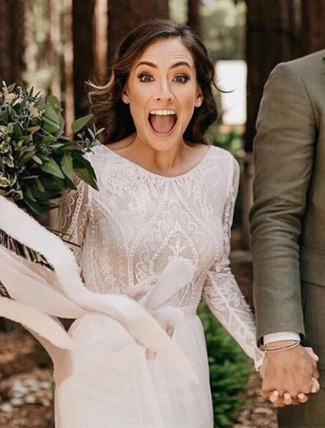 Full length view of a bride wearing a Boho lace wedding dress.