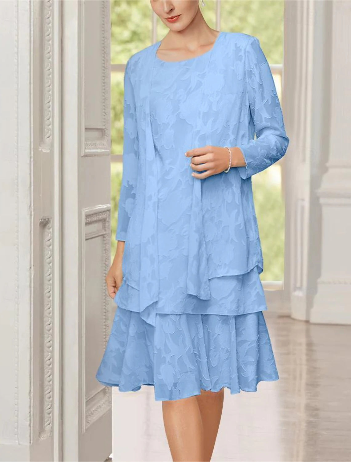 Tea-length formal dress for wedding guests, showing the flowing skirt and back detail.